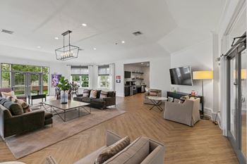 A living room with couches and chairs and a tv